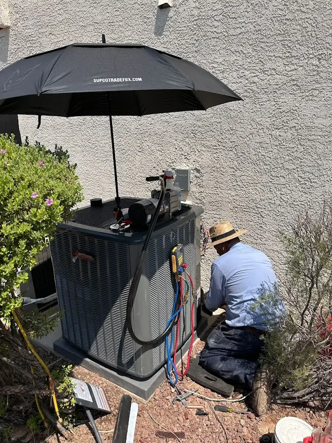 HVAC technician performing outdoor AC maintenance in Sylvester